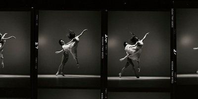 A sequence of four black & white photographs showing a male dancer lifting a female dancer against a plain studio backdrop
